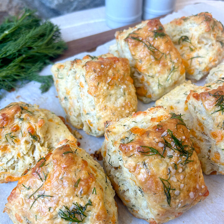 a tray of biscuits with cheese and dill