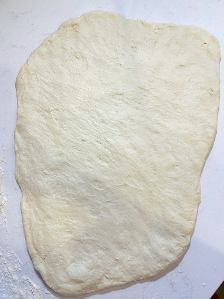 sourdough flatbread dough stretch into an oval 