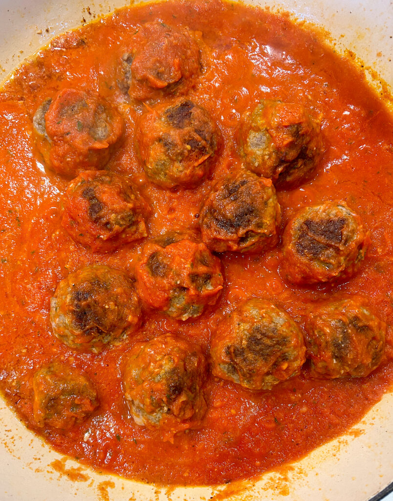 a pan of meatballs in tomato sauce