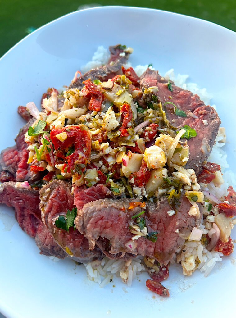 thinly sliced roast, over rice, with artichokes, tomatoes and feta cheese