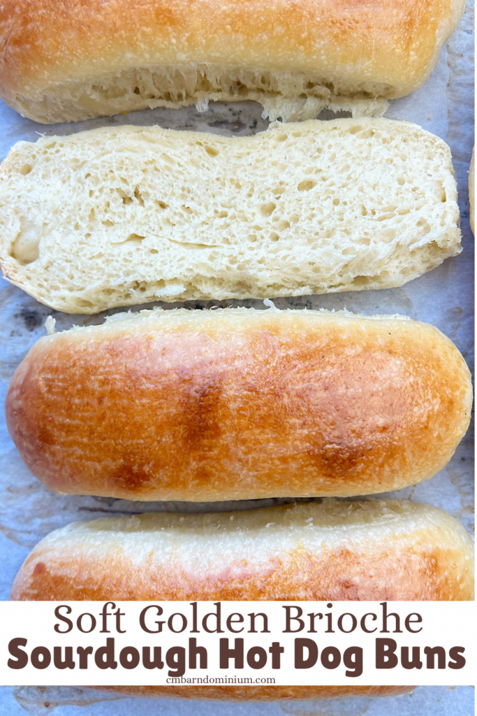golden hot dog buns on a baking sheet