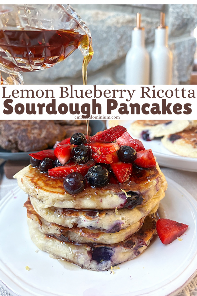 a stack of pancakes with strawberries and blueberries on top of a white plate 