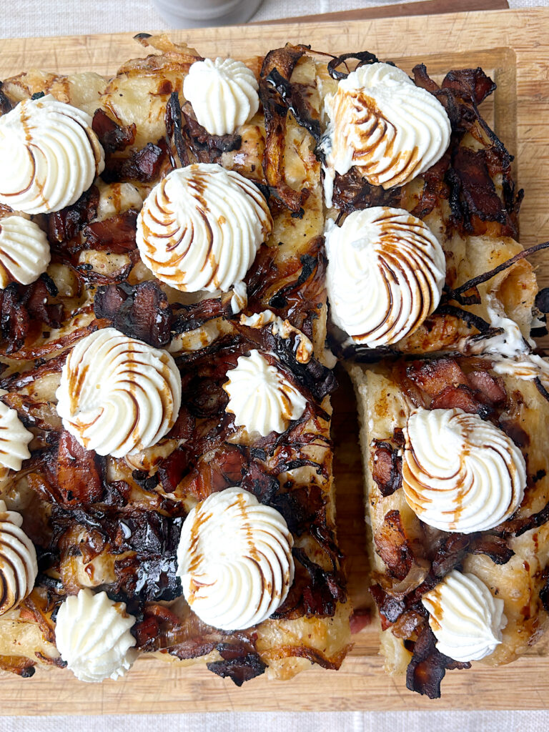 sliced bacon and onion focaccia bread with cheese dollops