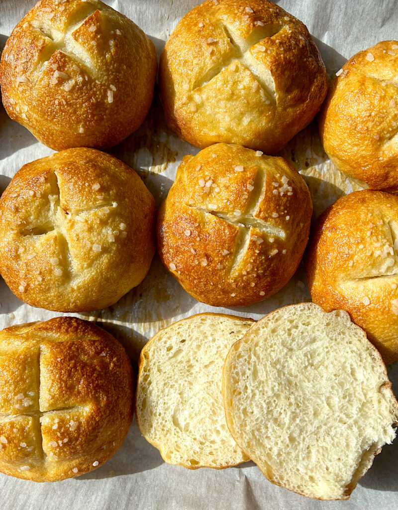 a baking sheets of golden pretzel buns 