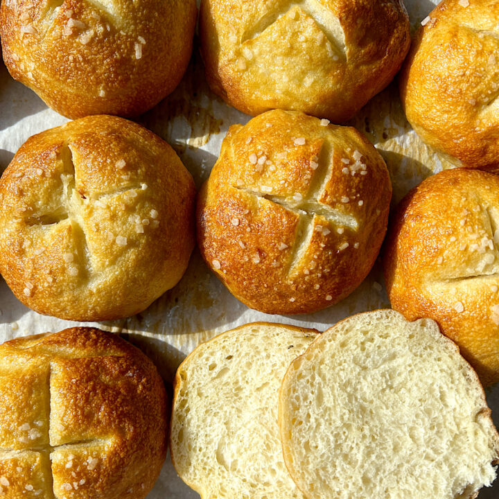 a baking sheets of golden pretzel buns