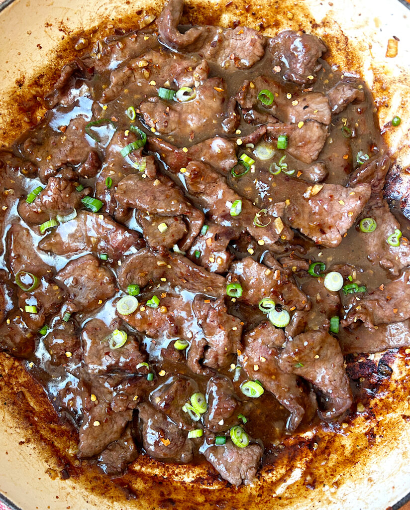 a skillet of stir fried venison with sweet chili sauce