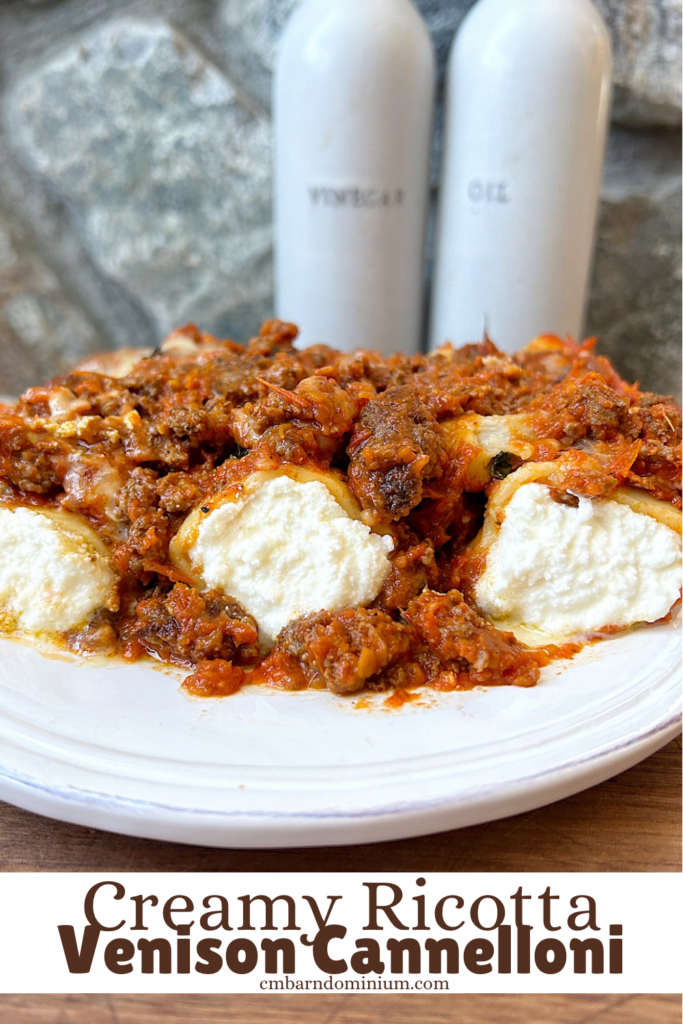 a white plate of ricotta stuffed pasta with tomato meat sauce