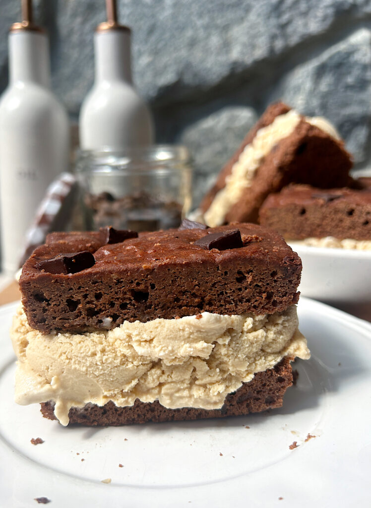 a white plate with a brownie and coffee ice cream sandwich