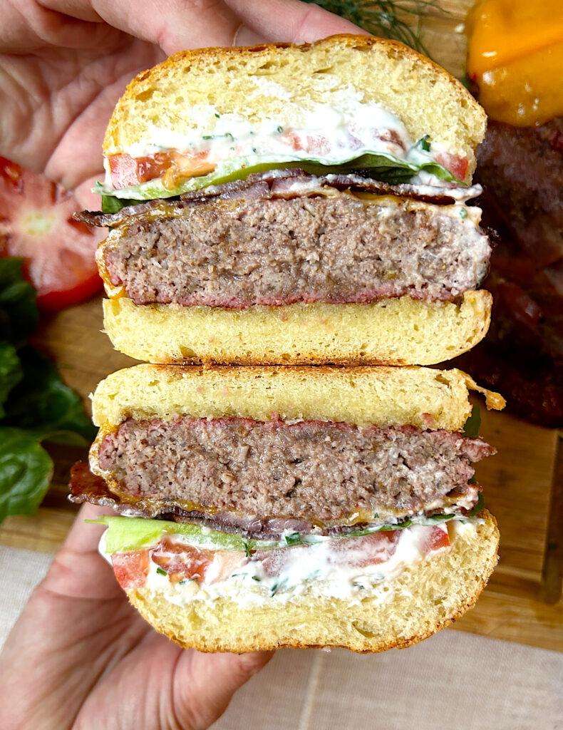 a hamburger cut in half on brioche bread