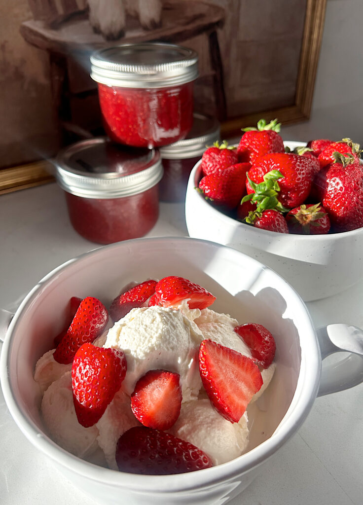 a white bowl of cereal cream with strawberries on top