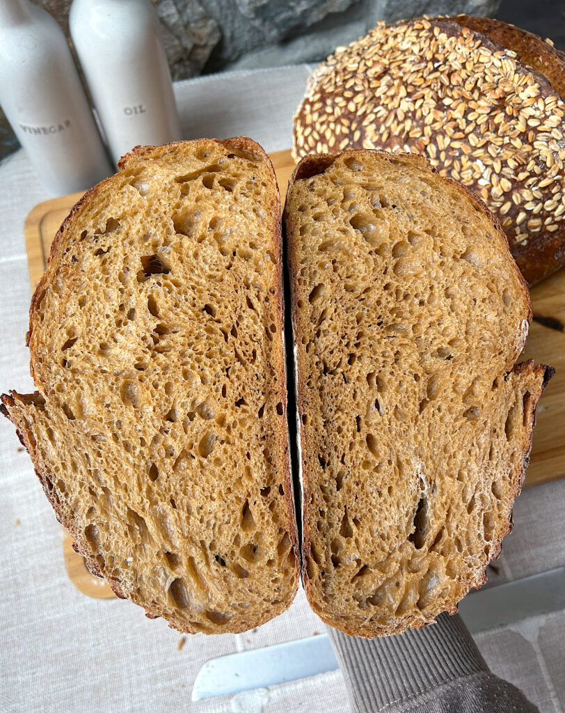 a loaf of brown sourdough bread cut in half