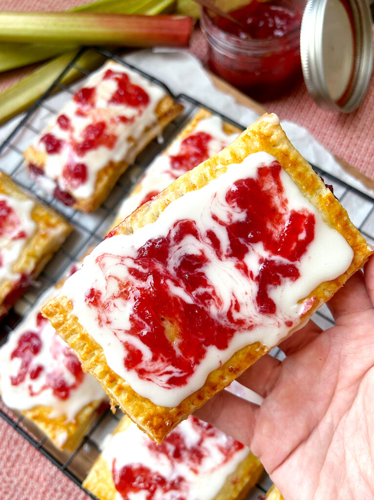 homemade pop tarts with strawberry rhubarb filling, and a vanilla, strawberry icing