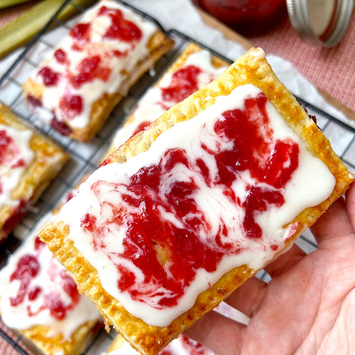 homemade pop tarts with strawberry rhubarb filling, and a vanilla, strawberry icing