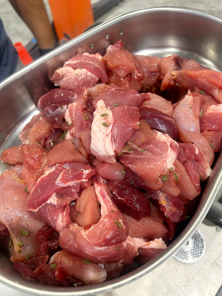 a stainless dish full of chunks of wild turkey and pork meat