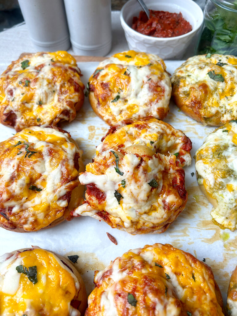 a tray of homemade soft pizza pretzels with cheese and fresh basil