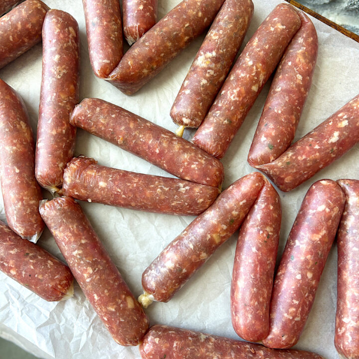 a tray of uncooked turkey sausage links