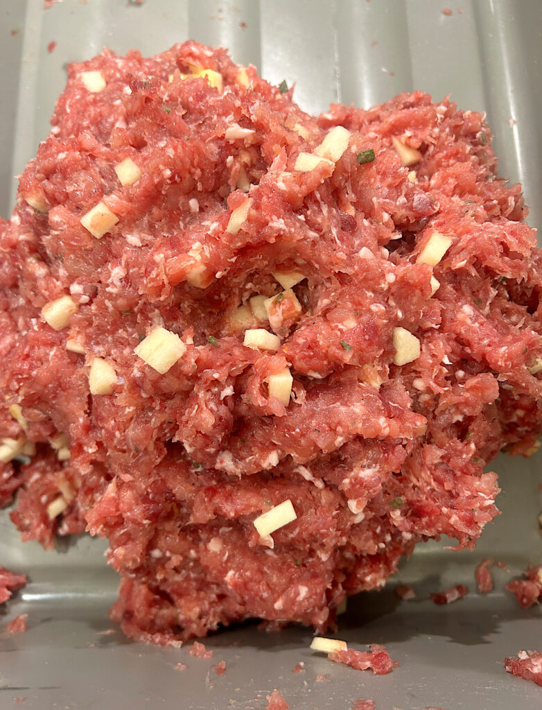 a mixture of uncooked apple sage turkey sausage meat