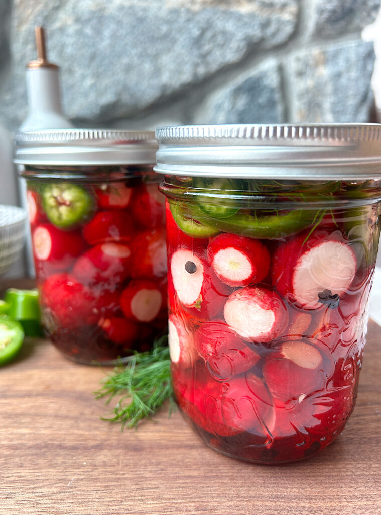 2 jars of pickles radishes with jalapeños 