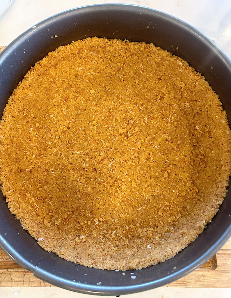 a cake pan with a graham cracker crust