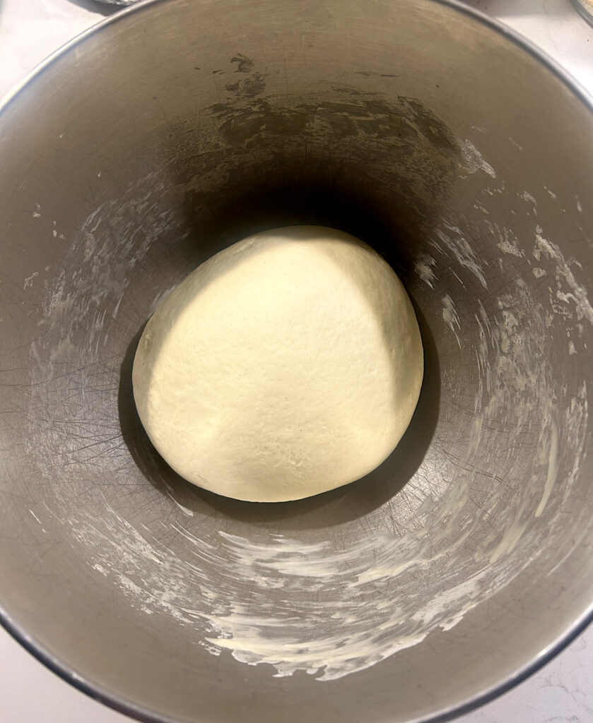 a stainless bowl of bread dough