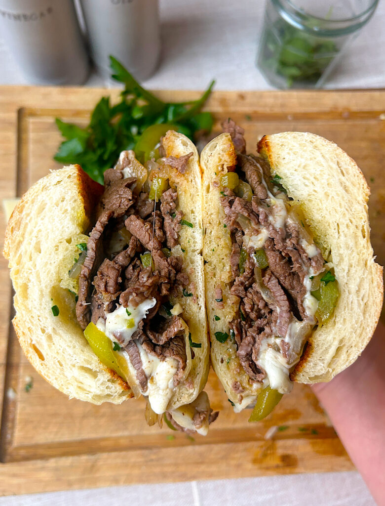 a philly cheesesteak sandwich cut in half