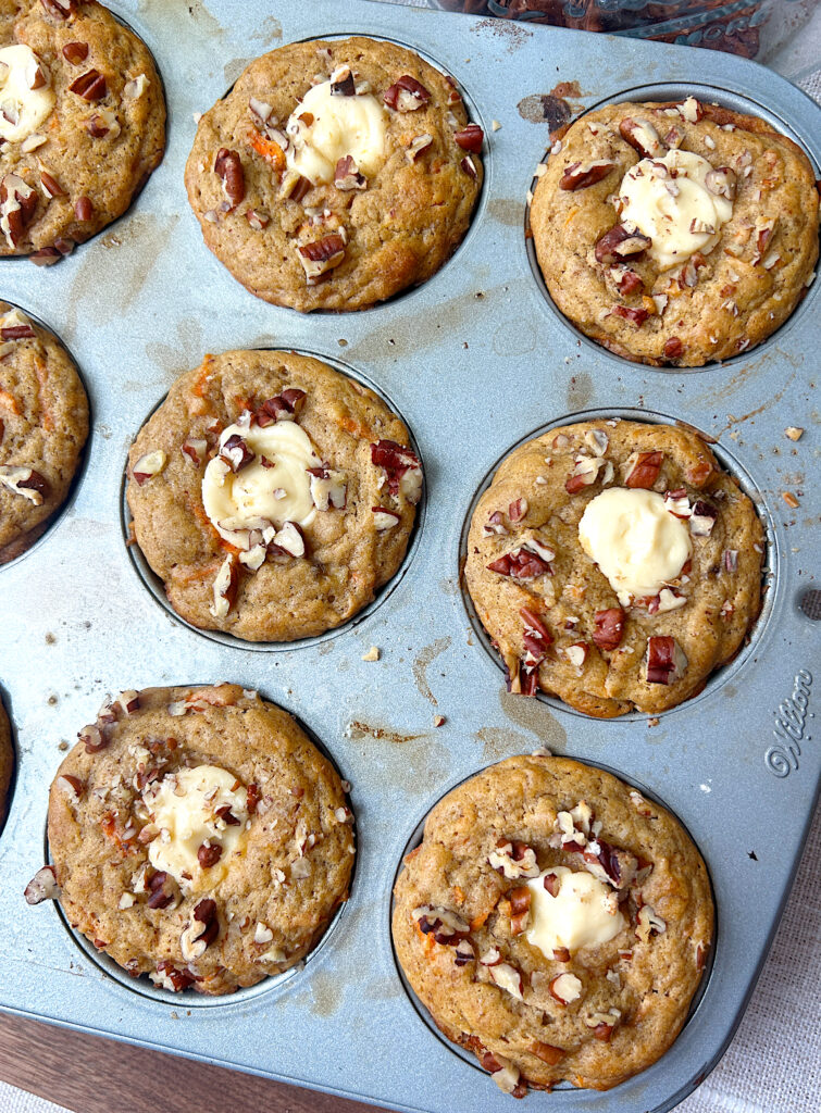 a tray of baked banana carrot muffins