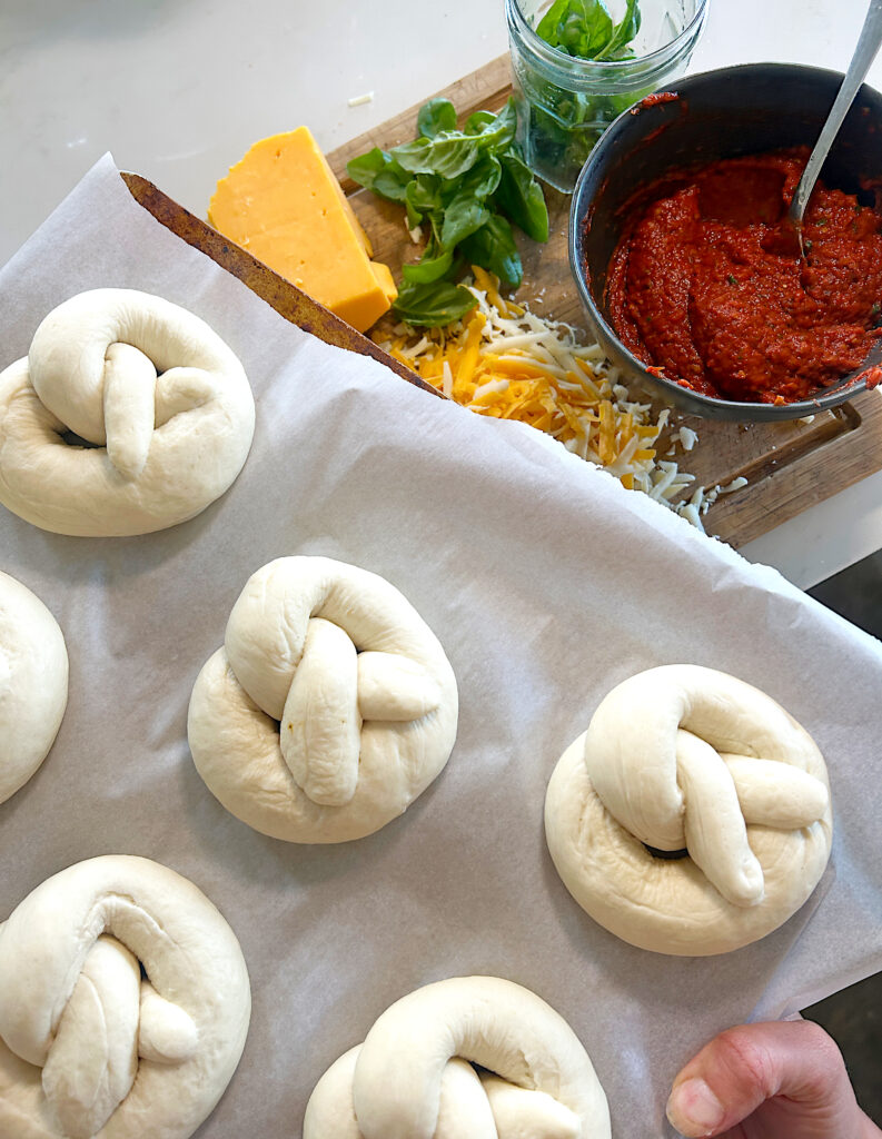 a baking sheet of unbaked soft pretzels