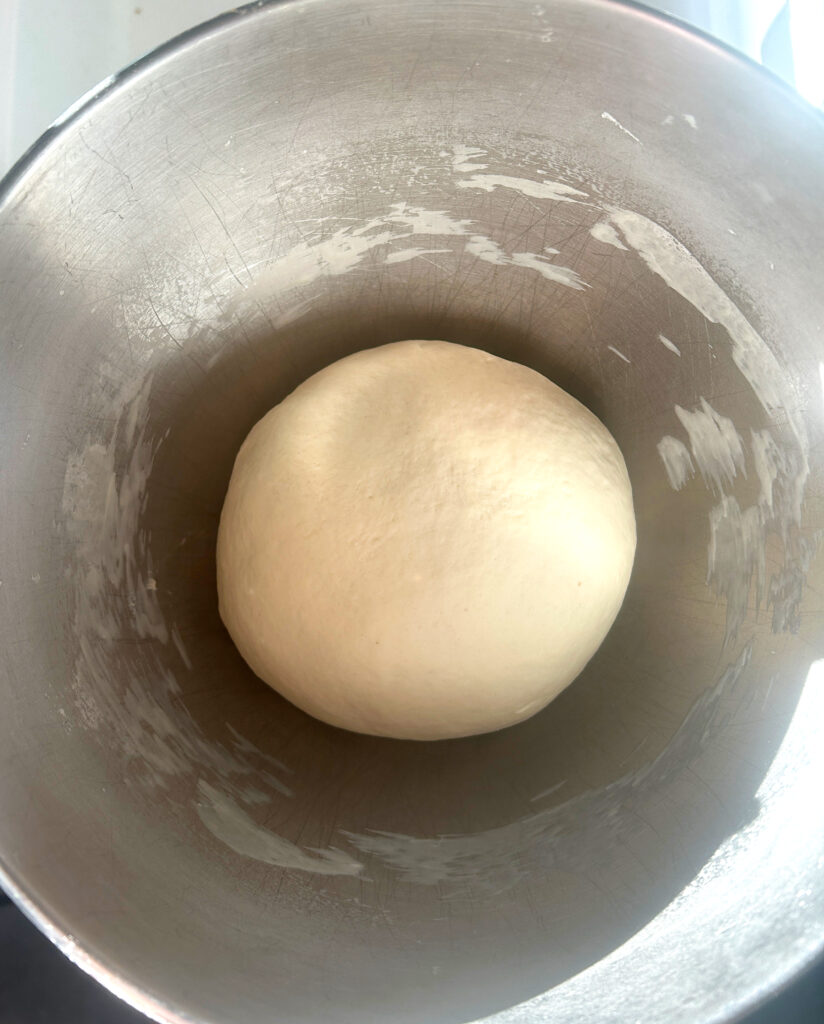 a stainless bowl of pretzel dough