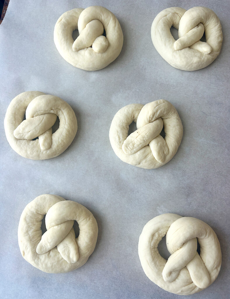 a baking sheet of unbaked soft pretzels
