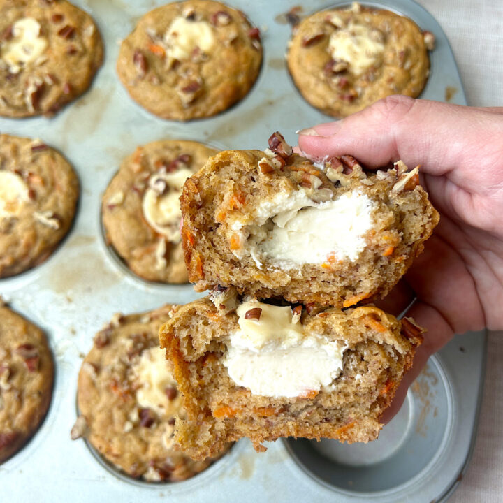 a carrot and banana muffin broken in half filled with cream cheese