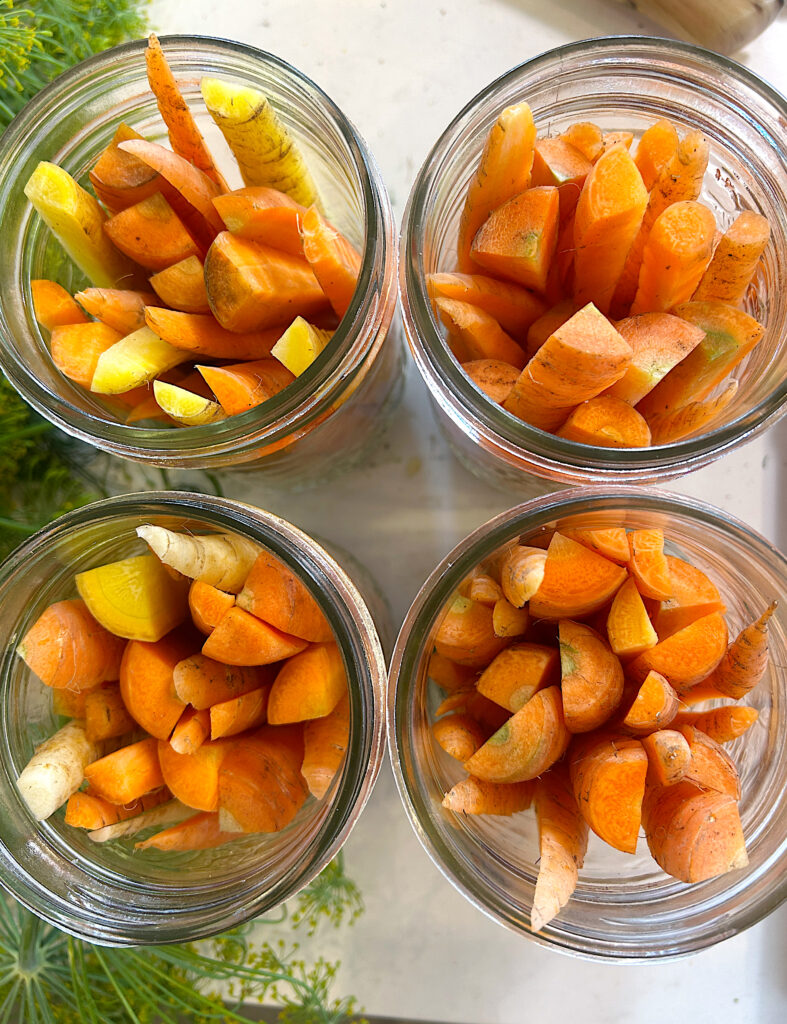 4 jars full of carrot sticks