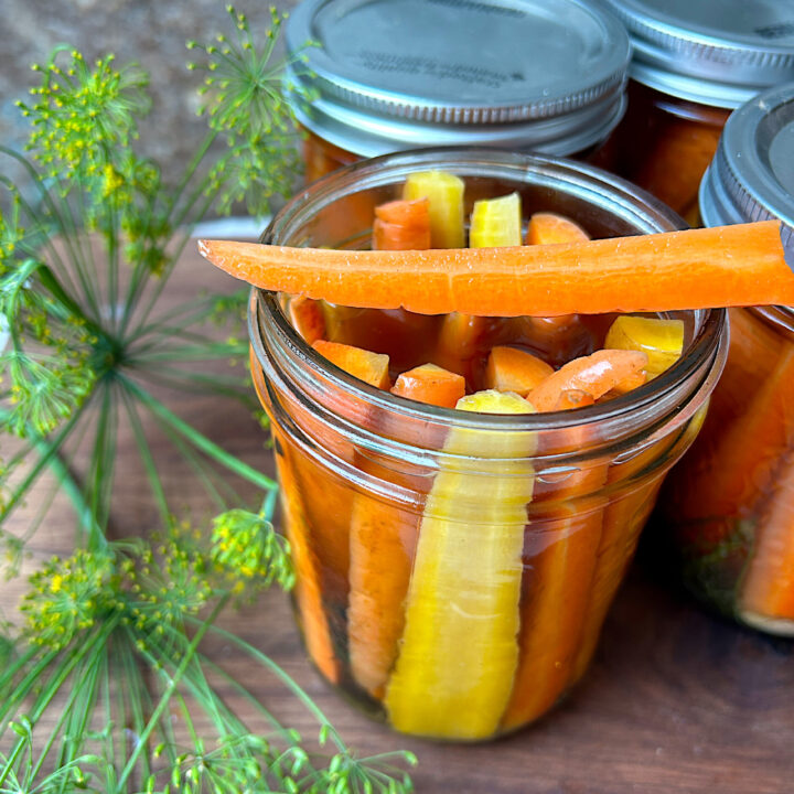 a jar of orange and yellow pickled carrots