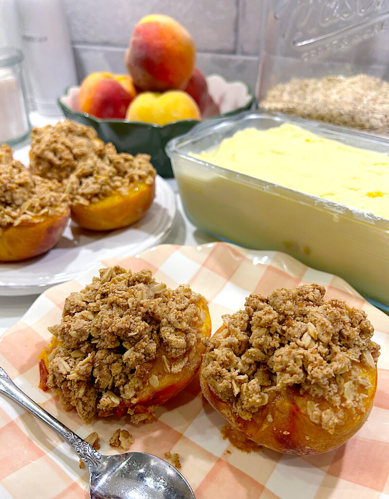 crumble topped baked peaches on a pink and white checkered plate