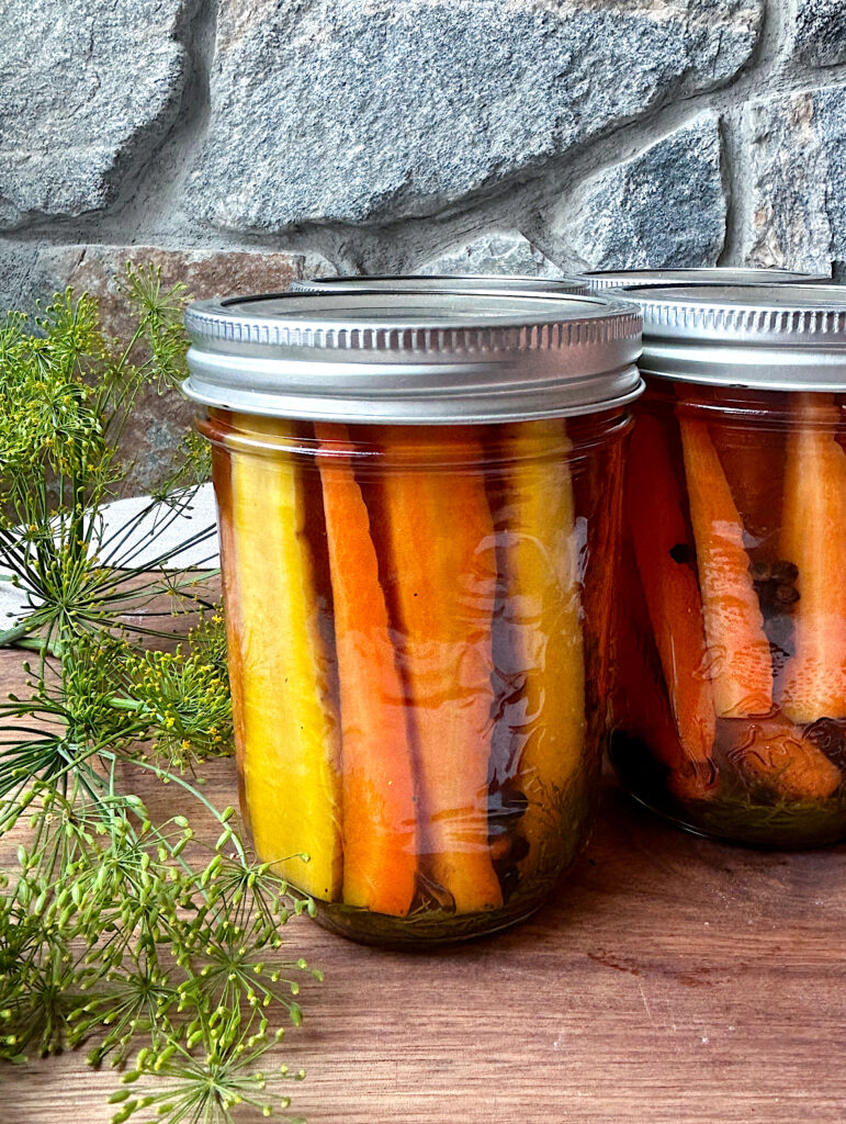 a jar of homemade pickled carrots with dill