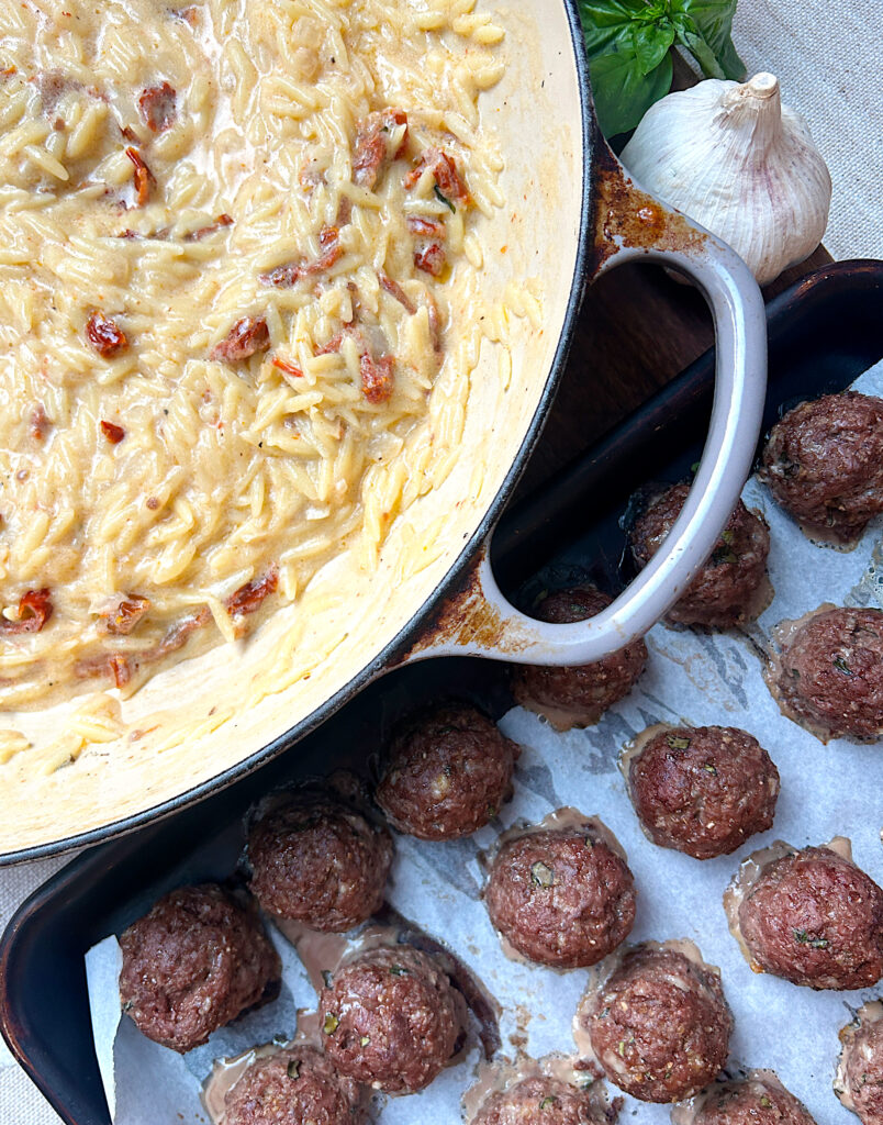 a tray of meatballs and a skillet of creamy orzo