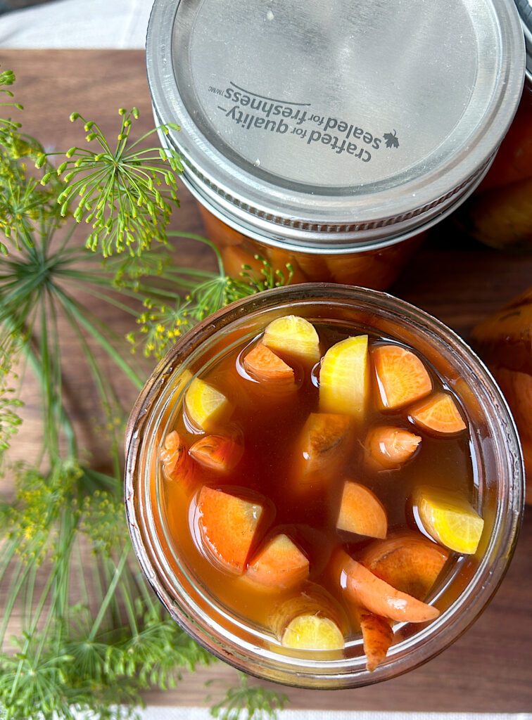 an open jar of pickled carrots 