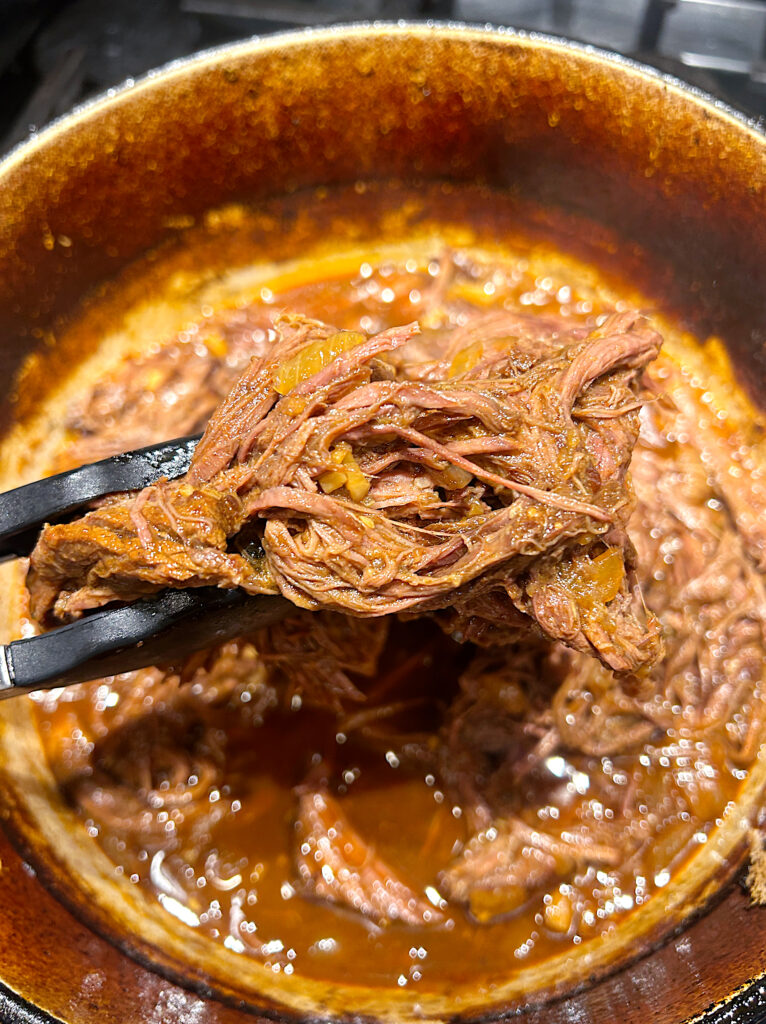 a pot full of shredded meat