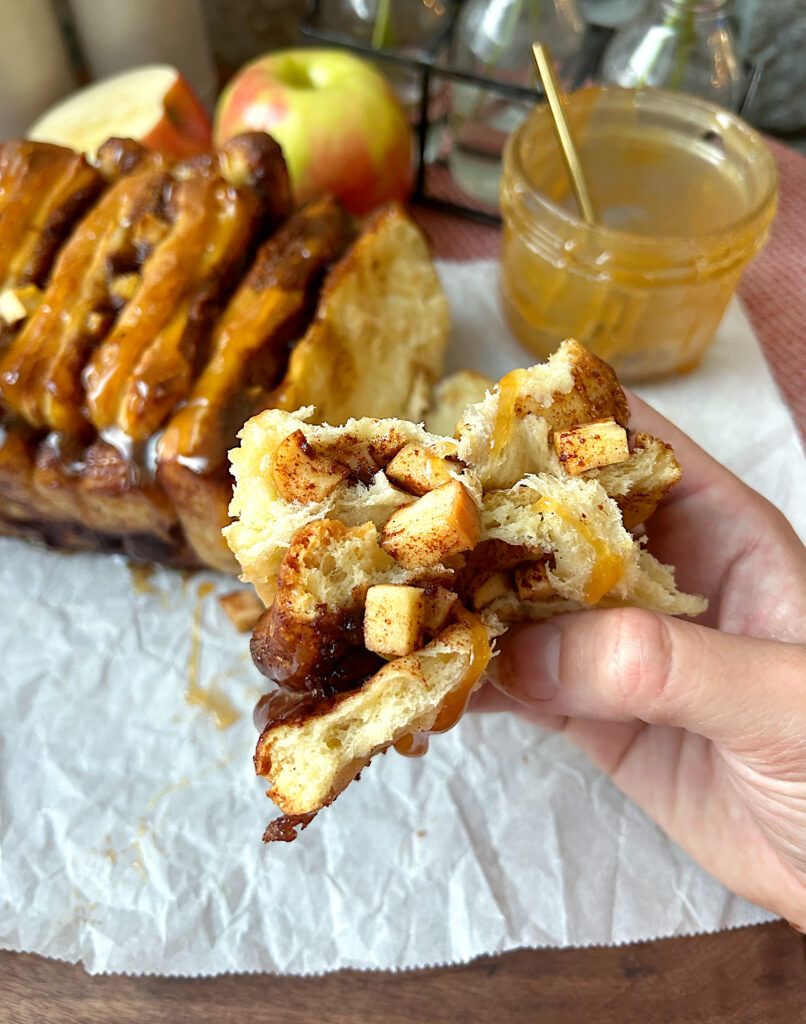 a piece of apple cinnamon bread broken in half