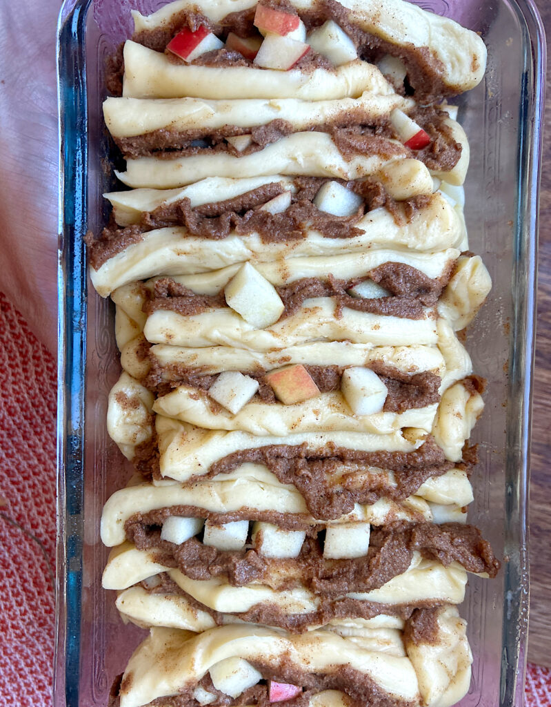 unbaked apple cinnamon bread in a glass loaf pan