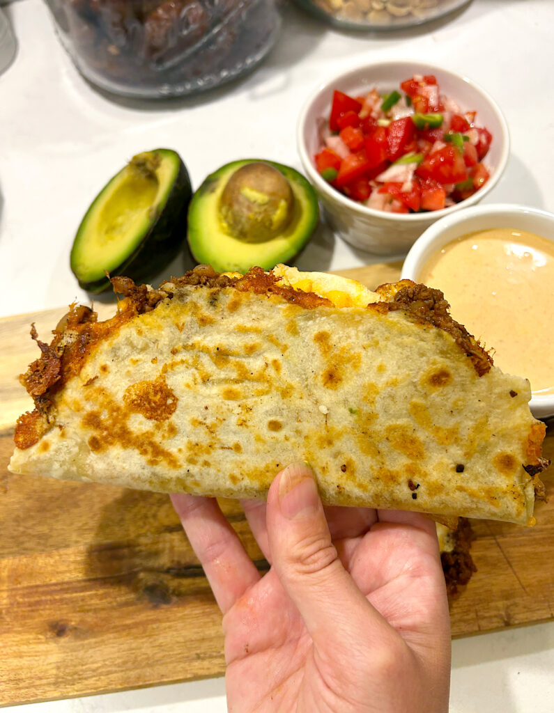a crispy tacos with meat and cheese