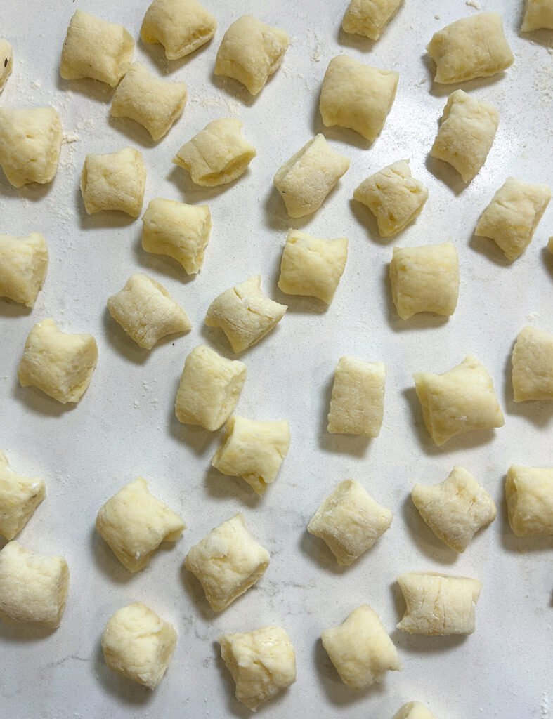a white counter with homemade gnocchis on top