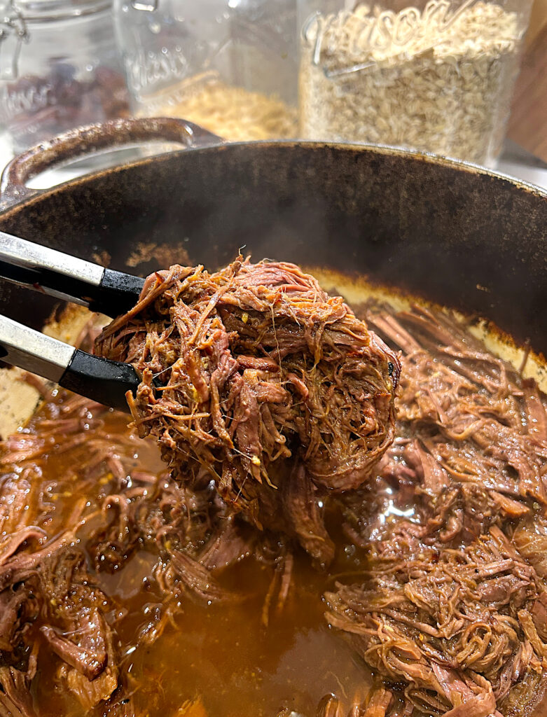 a pot of shredded venison in a sesame ginger sauce