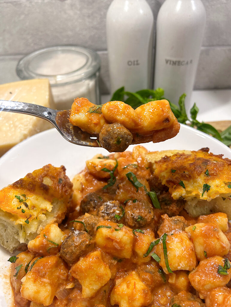 a dish of homemade gnocchi with mini venison meatballs in a tomato sauce