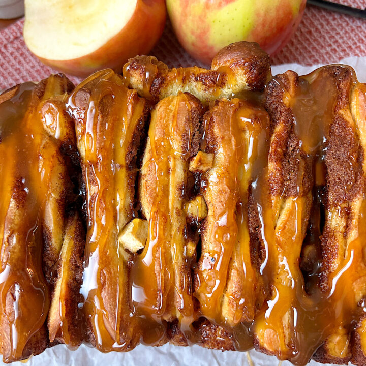 a loaf of pull apart bread with apples and caramel