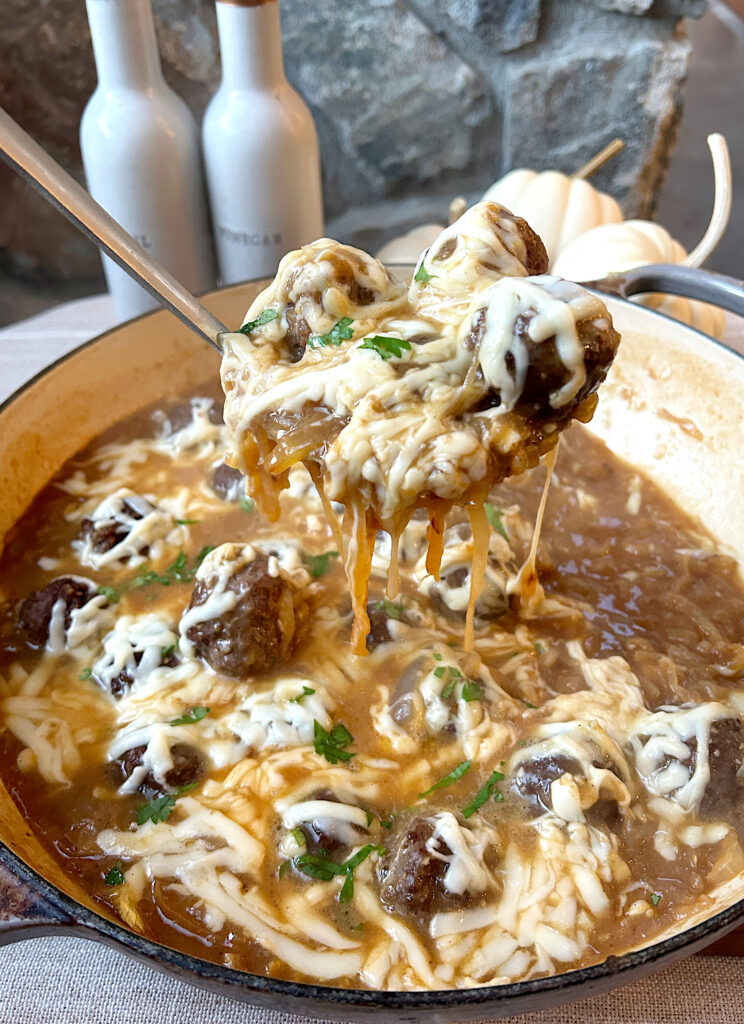 meatballs with caramelized onions and melted Swiss cheese on top