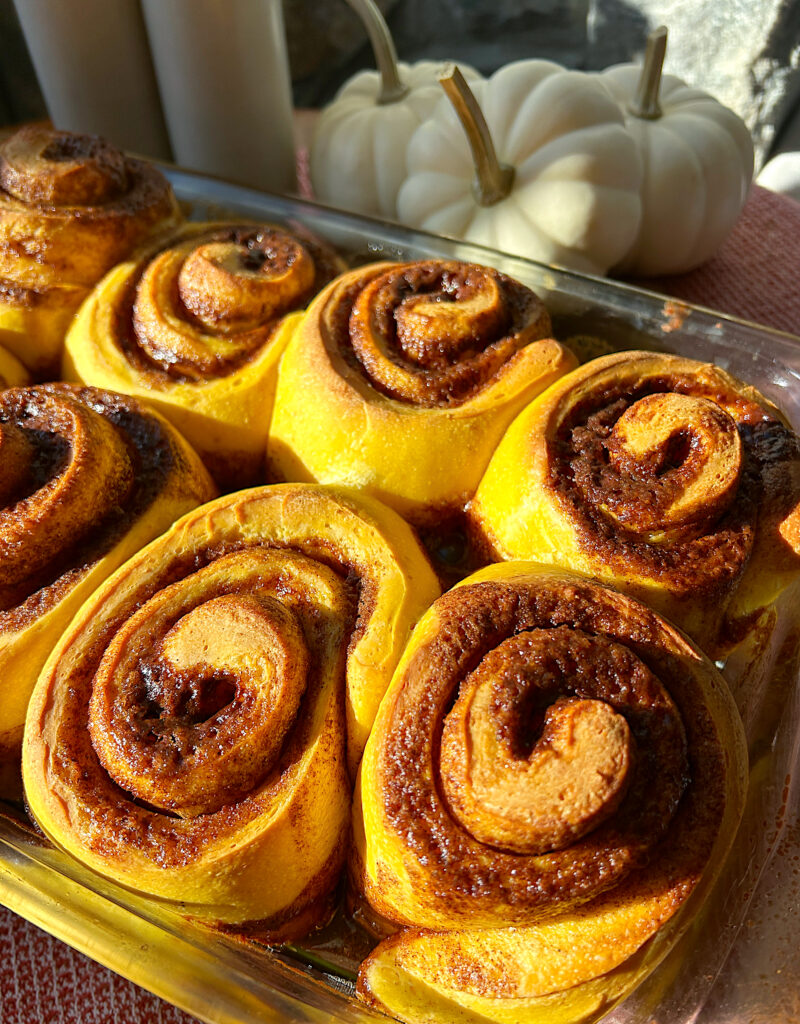 a tray of golden baked pumpkin cinnamon buns 
