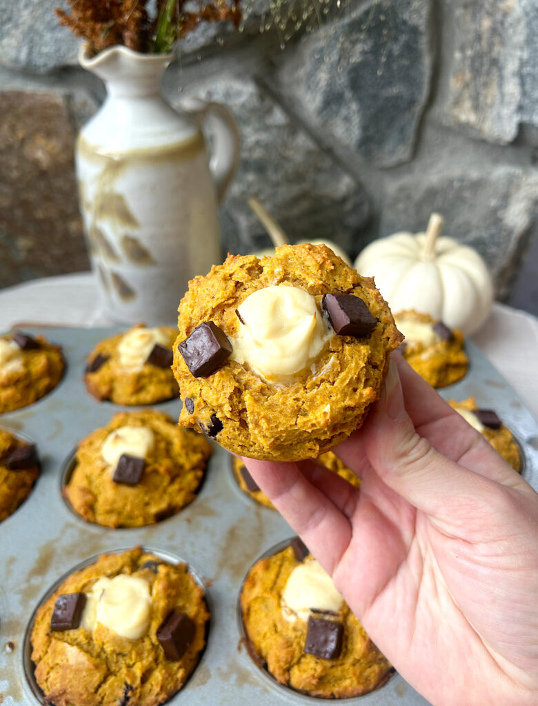 a baked pumpkin muffin with a cream cheese centre and dark chocolate