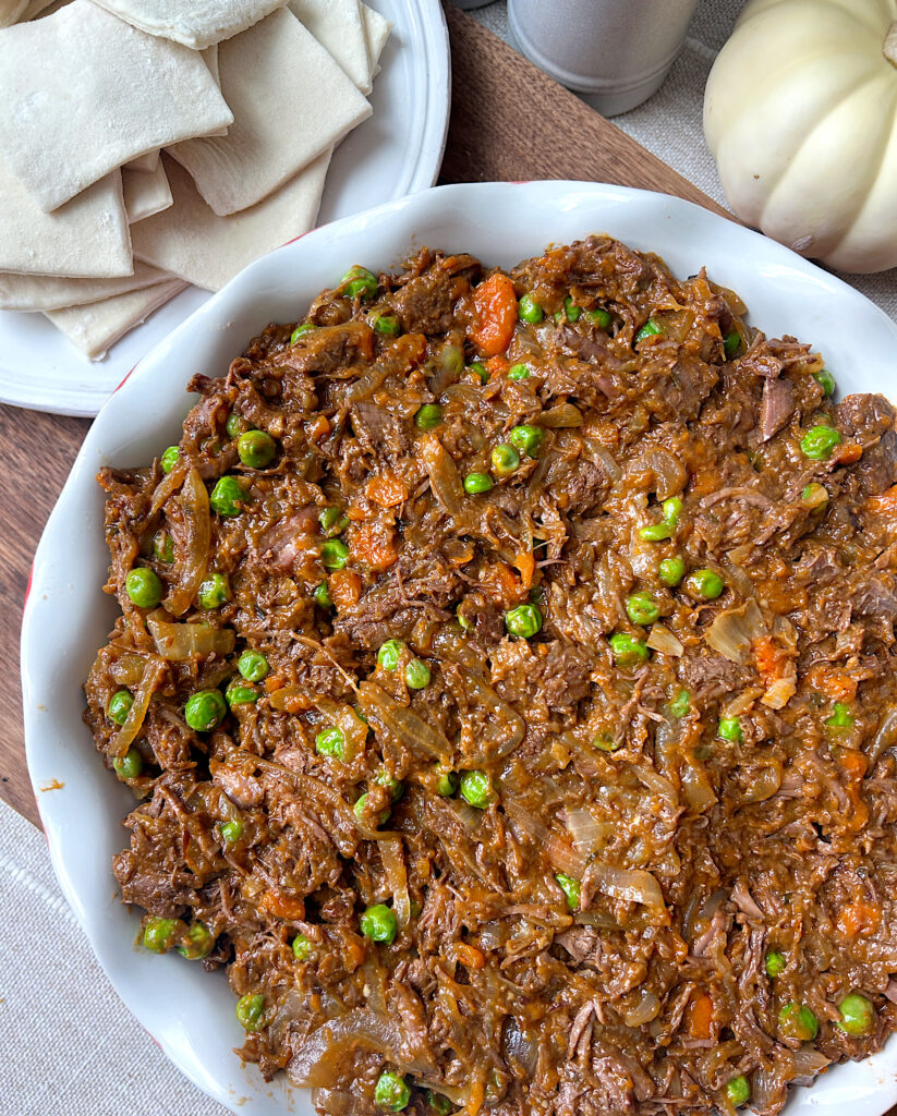 a pie dish full of a meat and vegetable filing