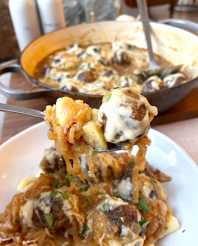 a spoonful of caramelized onions and a venison meatball