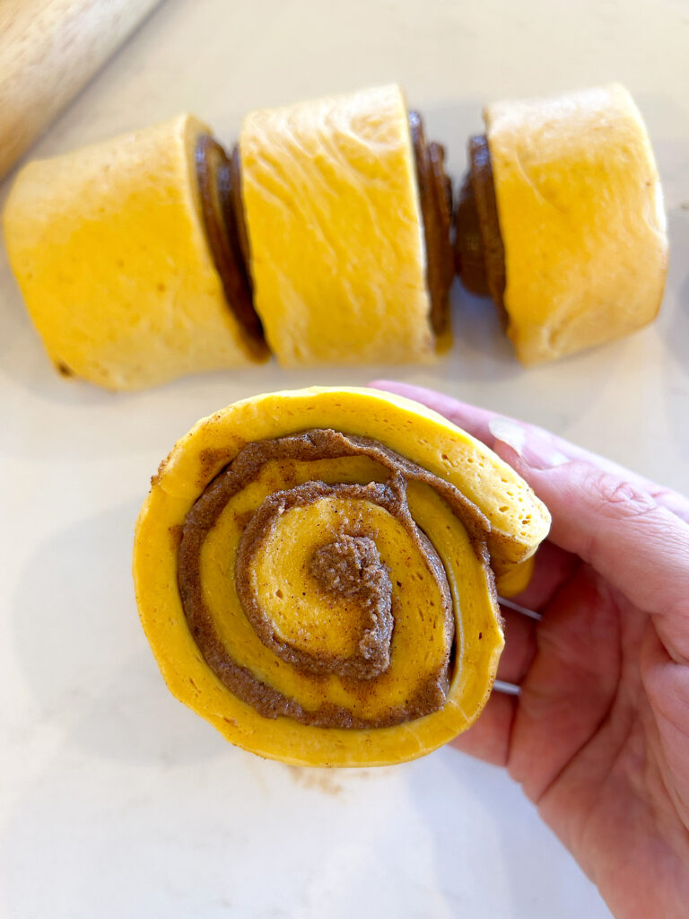 an unbaked pumpkin cinnamon bun